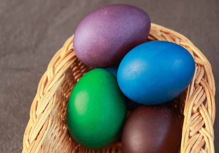 High angle view of multi colored eggs in basket