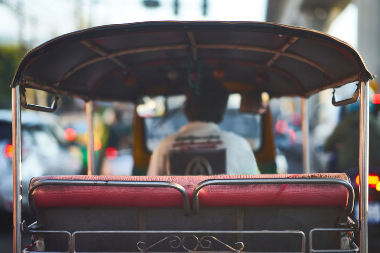 Tuk tuk or thai three wheels vehicle on blur background in rear aspect