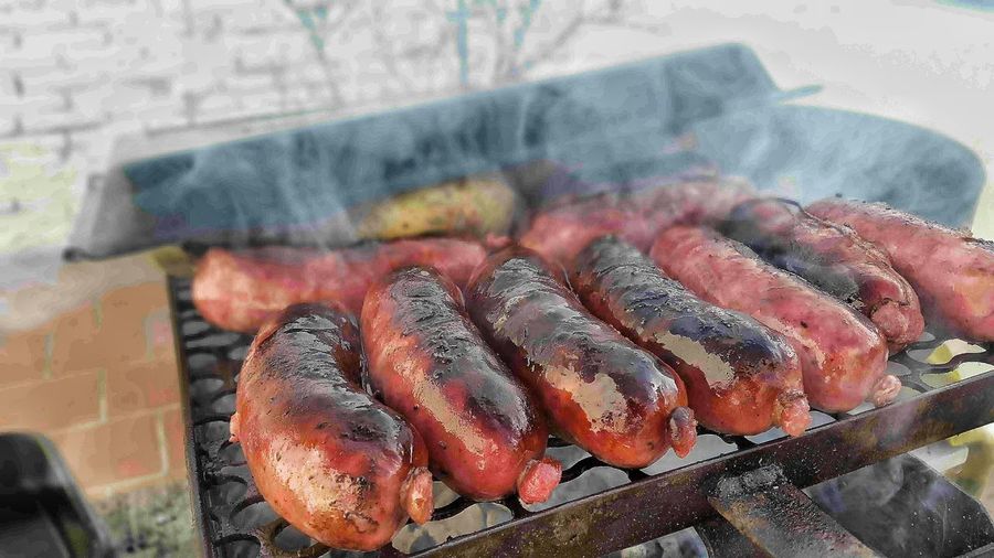 Close-up of sausages grilling on barbecue