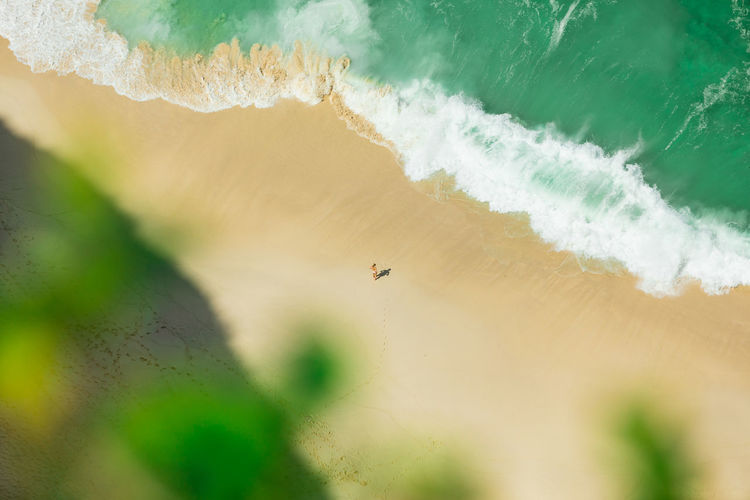 Aerial view of woman standing at seashore