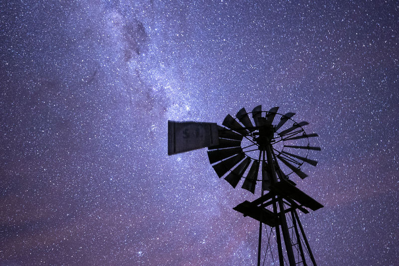 Low angle view of windmill against sky at night