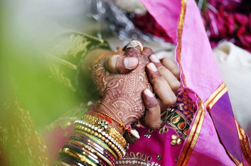 High angle view of couple holding hands during wedding ceremony