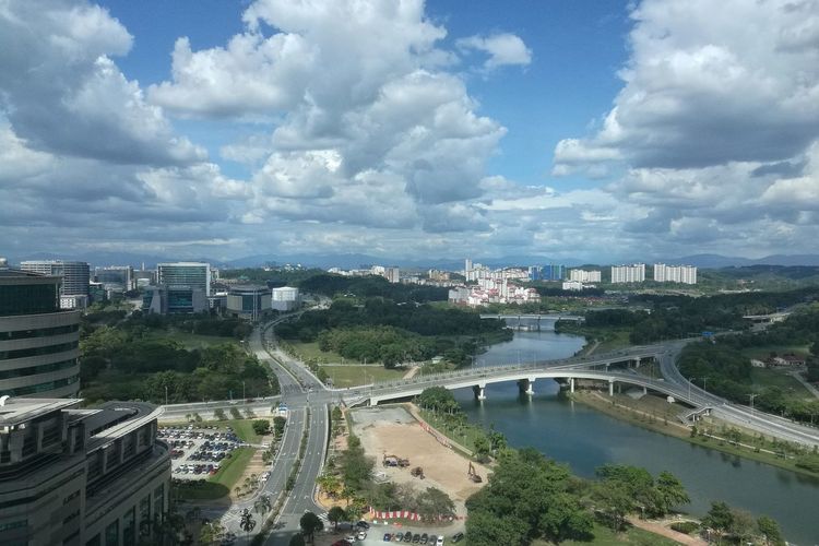 High angle view of bridge over river amidst buildings in city