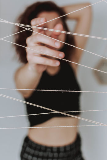 Defocuesd image of woman touching thread