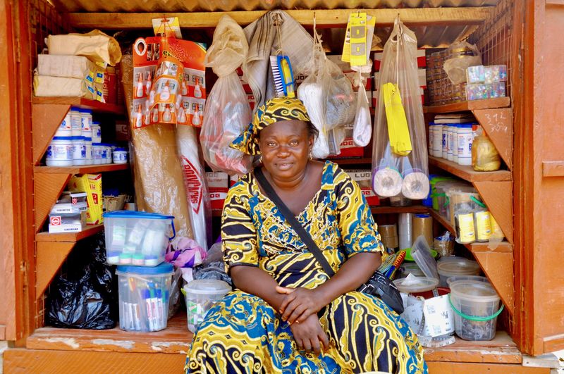 Portrait of female vendor sitting at store