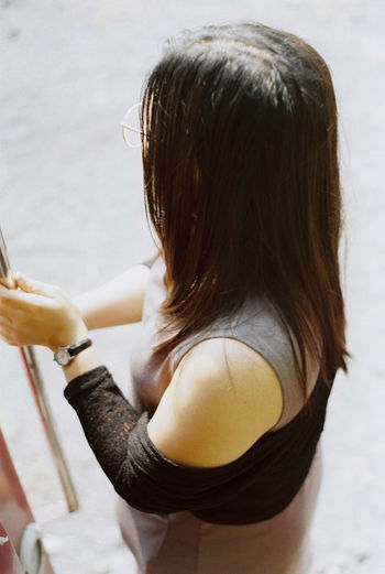 Rear view of woman standing against white background