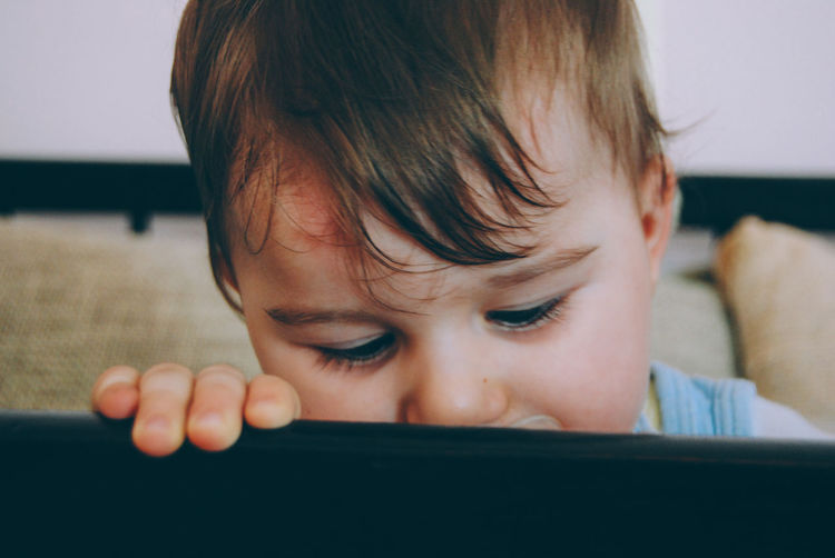 Close-up of baby boy in crib at home