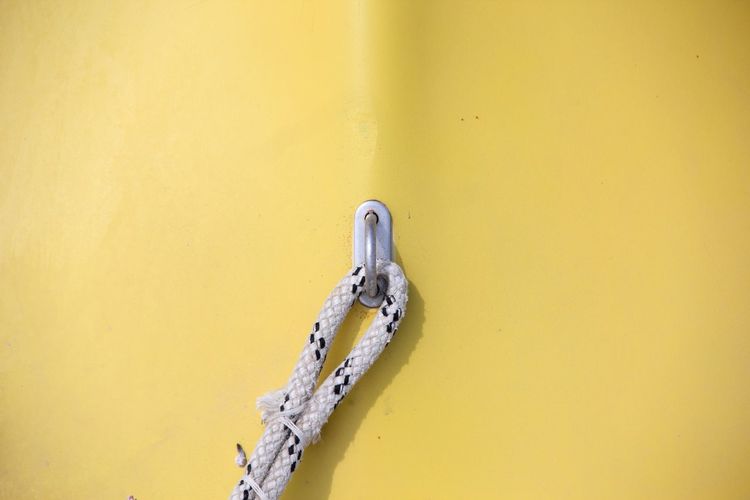 Rope attached on hook of yellow metal