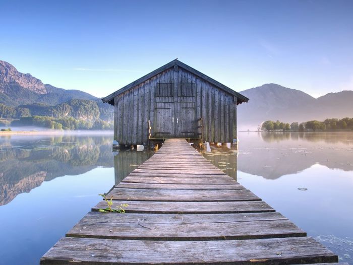 Wooden boat house. silent mountain lake and boat shed