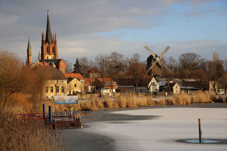 Houses by frozen lake