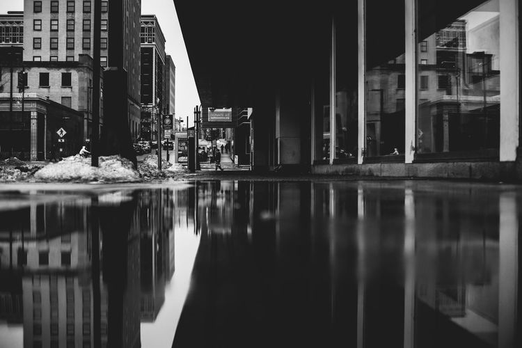 Reflection of buildings on street in city
