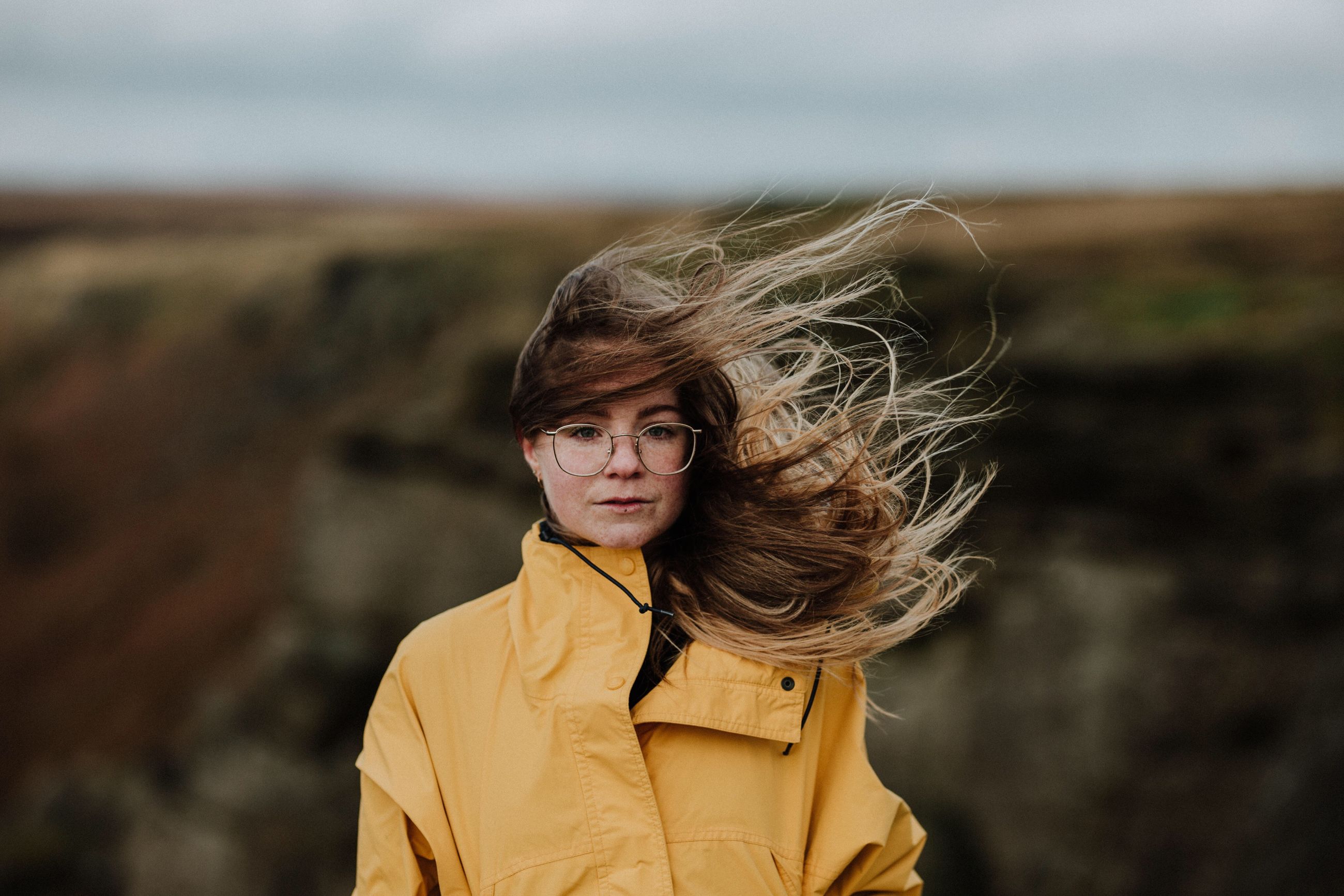 real people, focus on foreground, one person, young women, front view, casual clothing, looking at camera, leisure activity, young adult, lifestyles, standing, outdoors, day, nature, portrait, yellow, sky, beautiful woman, beauty in nature
