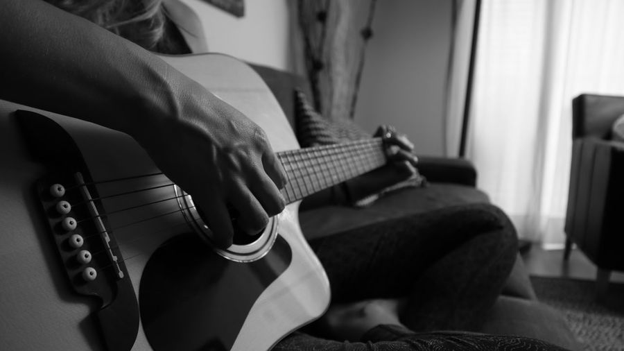 Man playing guitar at home