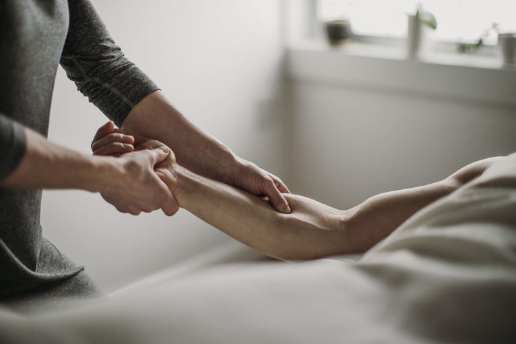 Close up of massage therapist treating patient's bicep