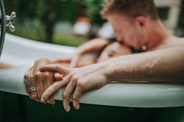 Couple in bathtub outdoors