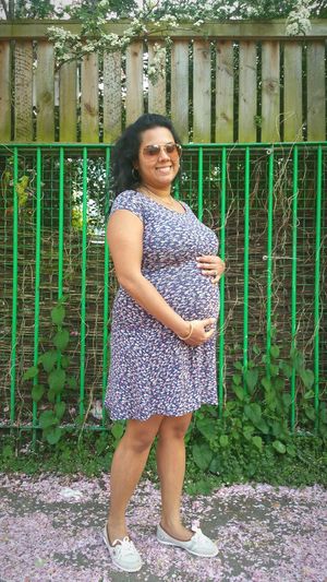 Happy pregnant woman standing at cathnor park childrens centre