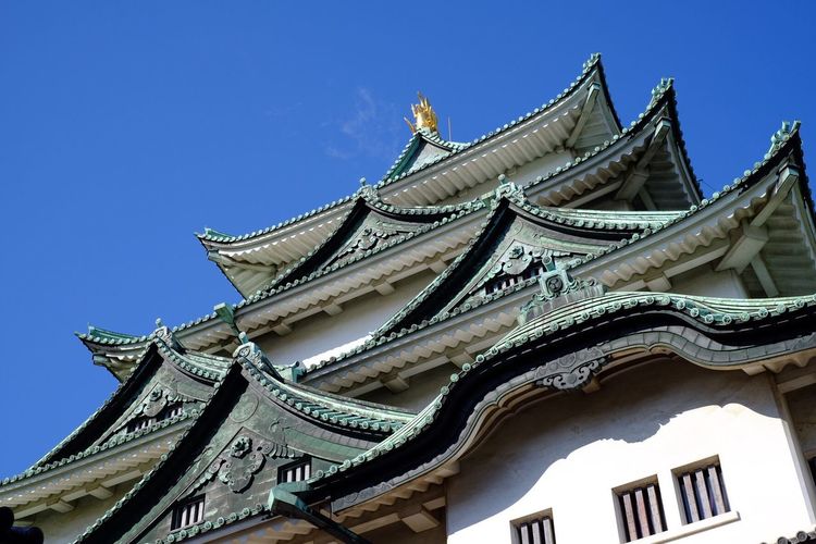 Low angle view of nagoya castle against clear blue sky
