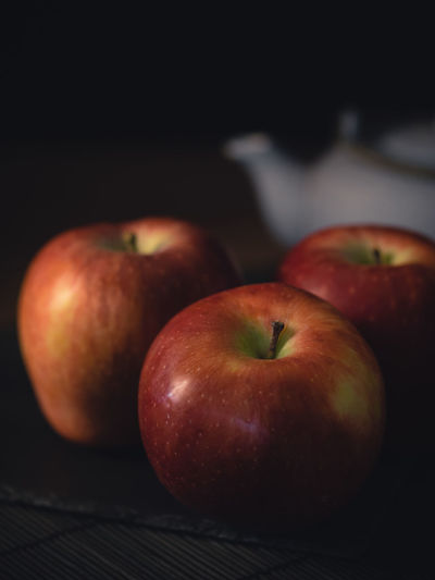 Red apples on dark background.