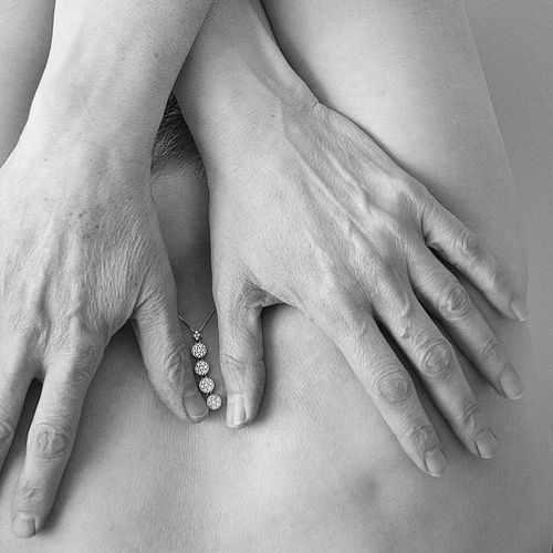 Midsection of woman touching back