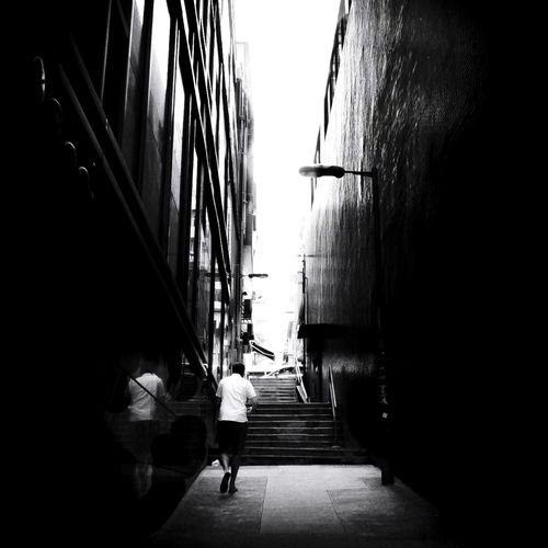 Man walking on narrow alley