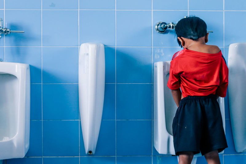 Boy urinating in toilet