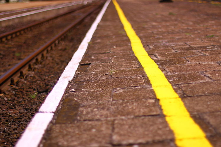 Surface level shot of lines on railroad station platform