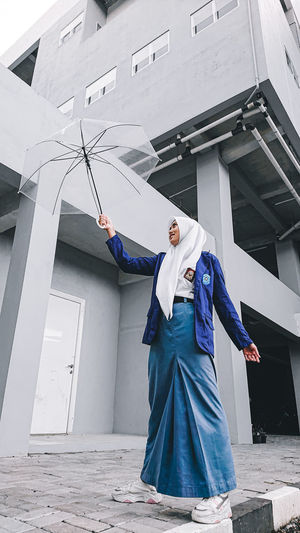 Young girl of senior highschool bring a transparent umbrella