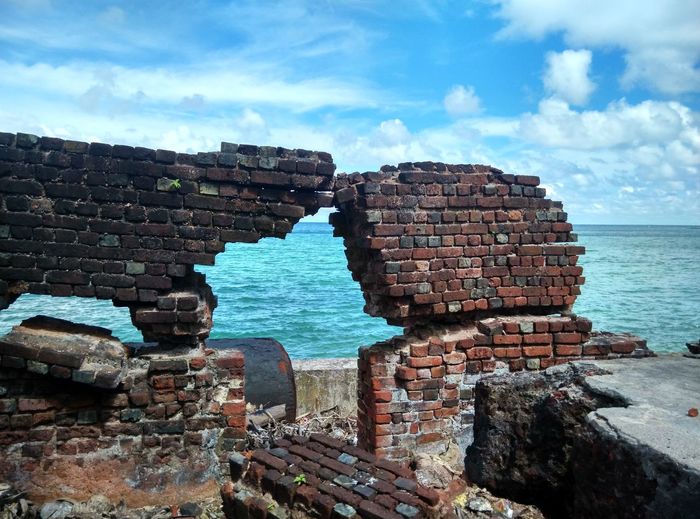 Damages brick wall by sea