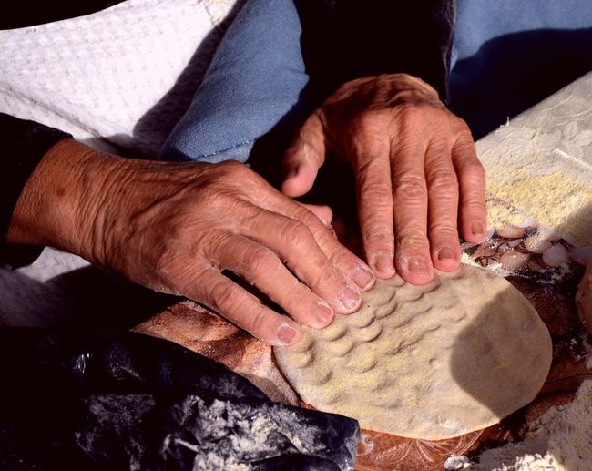 Cropped image of person making pita bread