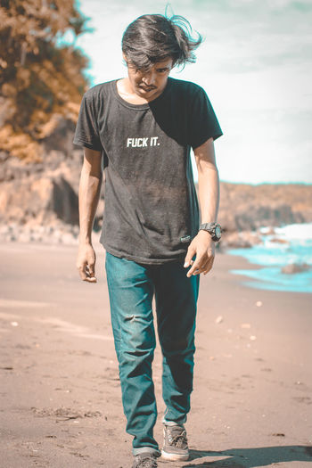 Full length of man walking on shore at beach