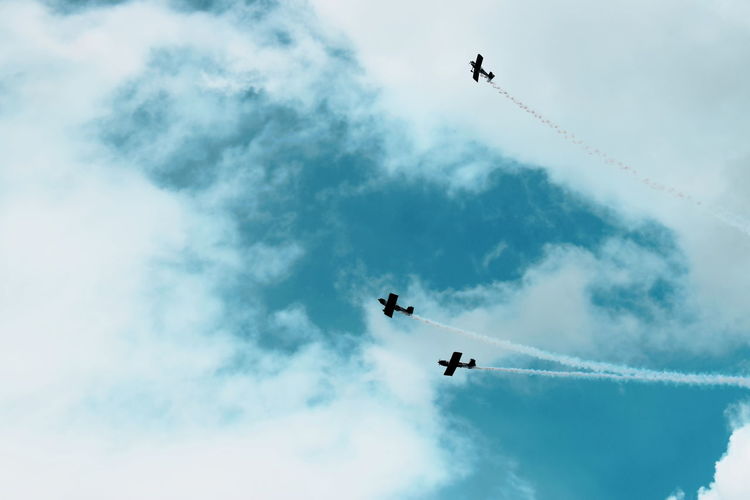 Low angle view of airshow against sky