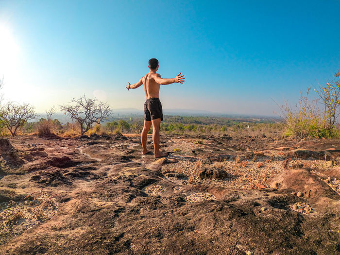 Full length of man standing on field against sky