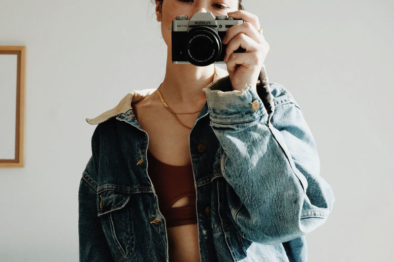 Midsection of woman photographing