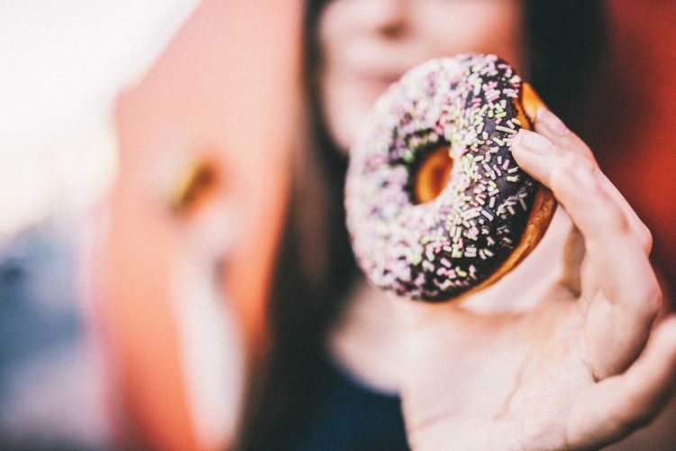 Close-up of woman holding donut