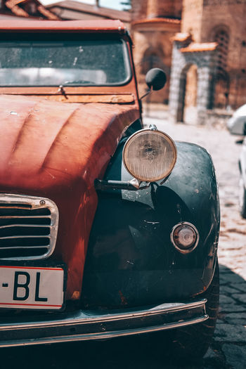 Close-up of old vintage car on street