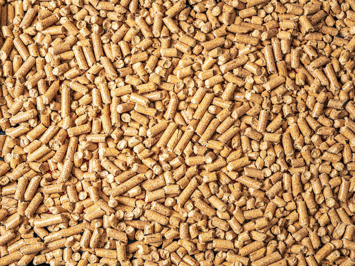 Natural wooden pellets background as renewable energy. close-up wood pellet pattern. top view