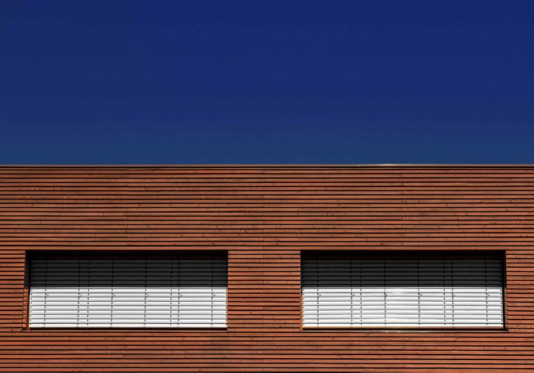 Low angle view of building against clear blue sky