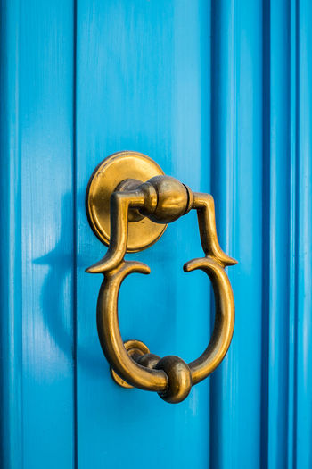 Close-up of blue door knocker