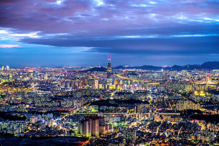 High angle view of city lit up at night