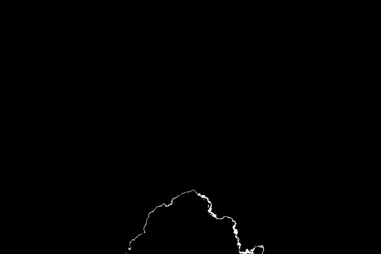 Low angle view of silhouette against black background